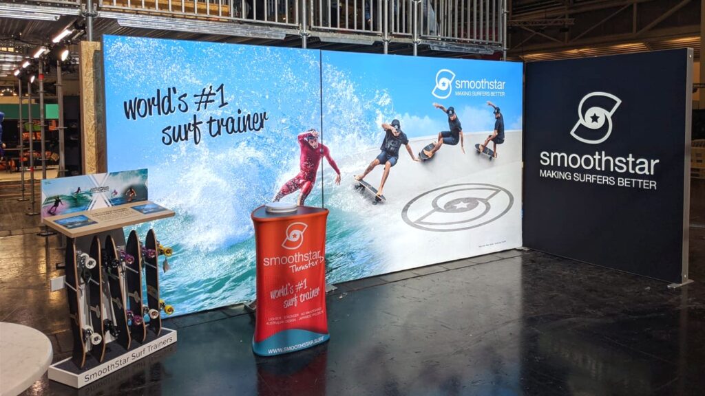 Backlit SEG trade show booth display for Smoothstar surf trainers with modular frames and fabric graphics