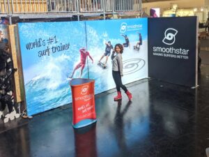 Modular SEG light box trade show booth with backlit fabric graphics and promotional counter at exhibition