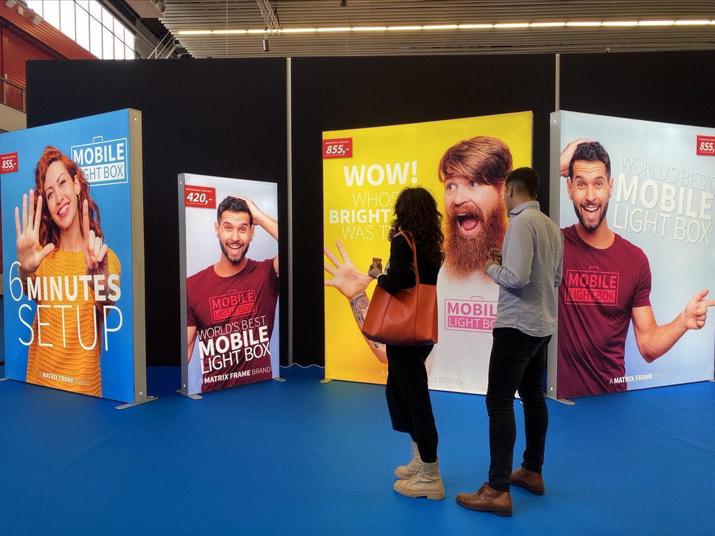 Modular SEG light box displays at trade show booth with backlit fabric graphics and portable LED frames