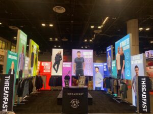 Modular backlit trade show display booth with portable SEG light boxes and fabric graphics for apparel brand
