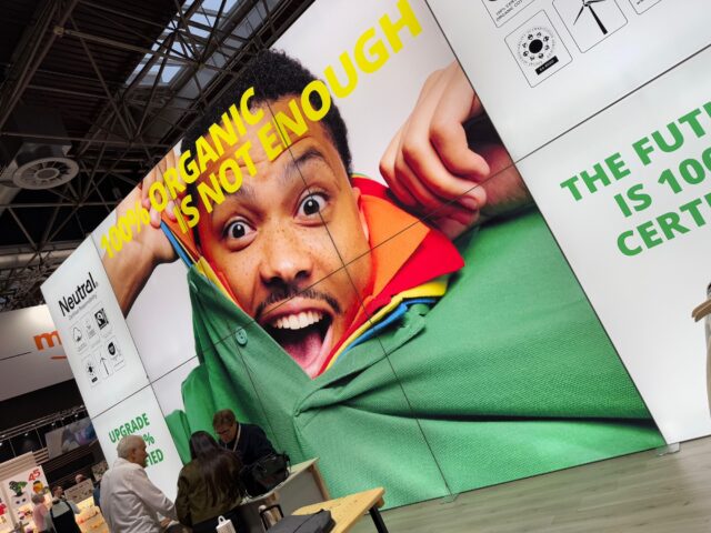 Large backlit SEG light box displaying vibrant graphics at trade show booth with modular aluminum frame system