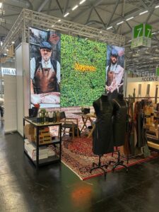 Modular SEG light box trade show booth with backlit graphics and green wall display at exhibition hall
