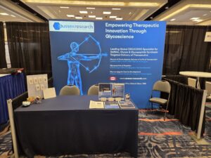 Backlit SEG light box trade show booth display with blue graphic and table at conference exhibit hall