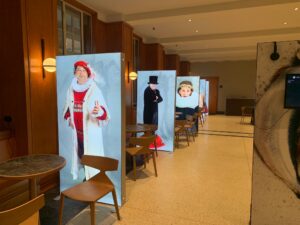 Portable SEG light boxes displaying life-size costume character graphics in hotel lobby or event space