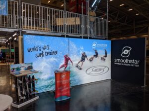 Backlit SEG trade show booth display for Smoothstar featuring modular fabric graphics and LED illumination