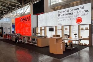 Modular SEG light box trade show booth with backlit banners and product displays at industry exhibition
