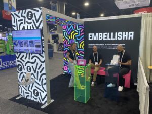 Modular SEG light box displays with backlit graphics at trade show booth featuring colorful patterns and branding