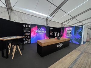 Modular SEG light box trade show booth with backlit graphics and custom branded counter display