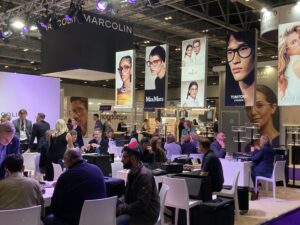 Backlit SEG displays with fabric graphics at crowded trade show exhibition featuring eyewear brands