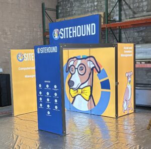 Modular SEG light box trade show booth display with custom branded graphics and backlit panels in warehouse